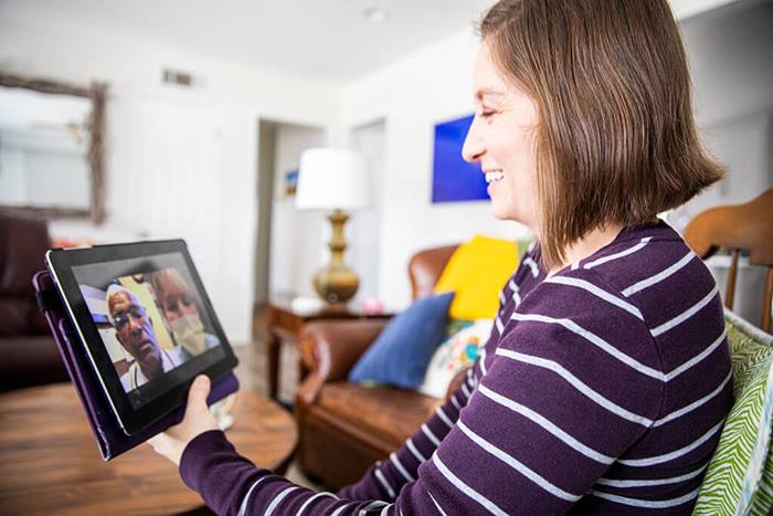 woman using tablet for telehealth visit