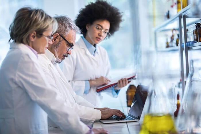 doctors analyzing data on laptop