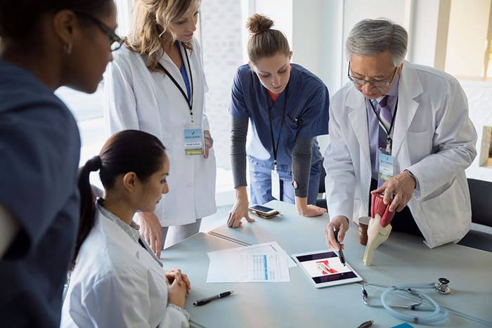 Medical professionals observing demonstration