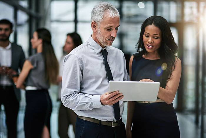 man and woman looking at tablet