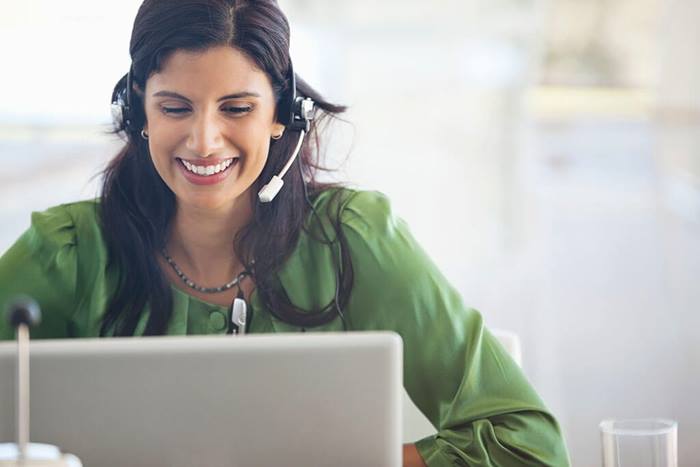 businesswoman wearing headset at desk